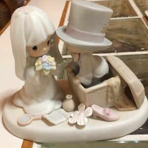 Vintage Precious Moments with bride holding her bouquet and groom.